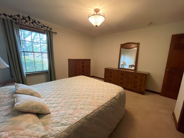 bedroom featuring light carpet