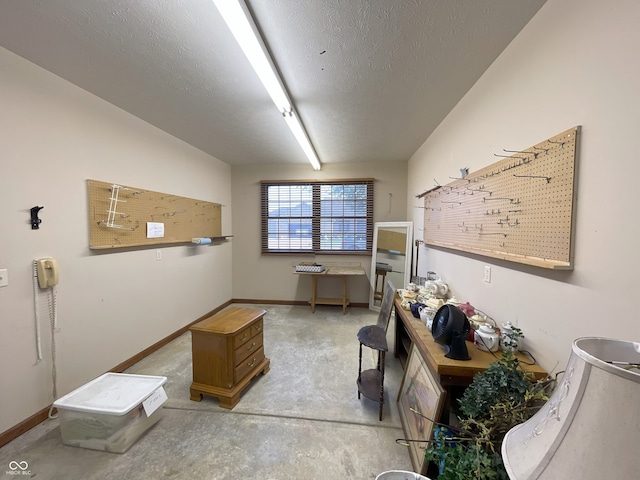 misc room with concrete flooring, a textured ceiling, and baseboards