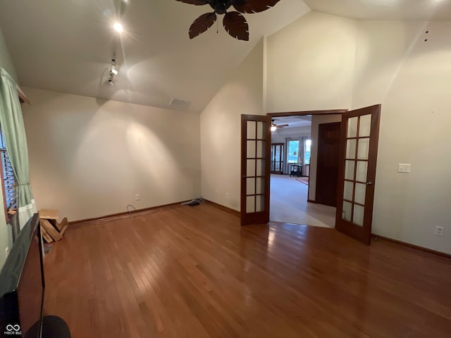 interior space with high vaulted ceiling, french doors, hardwood / wood-style floors, and ceiling fan