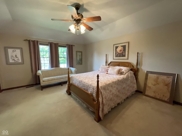 bedroom featuring ceiling fan, baseboards, and light colored carpet