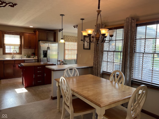 dining room featuring carpet flooring and a notable chandelier