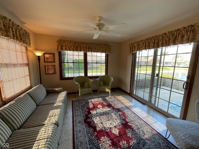 living room featuring tile patterned floors and ceiling fan