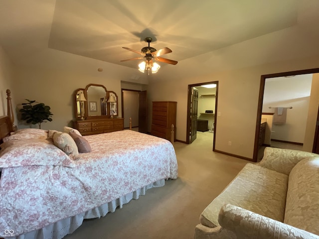 bedroom with a walk in closet, a closet, a ceiling fan, light carpet, and baseboards