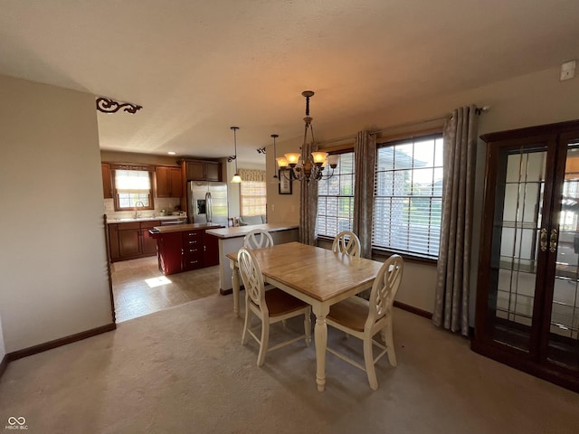 dining space featuring baseboards and an inviting chandelier