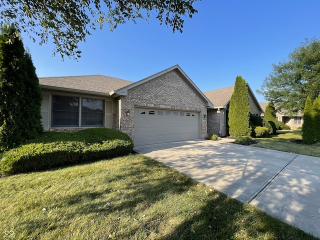 ranch-style house featuring brick siding, roof with shingles, concrete driveway, an attached garage, and a front lawn