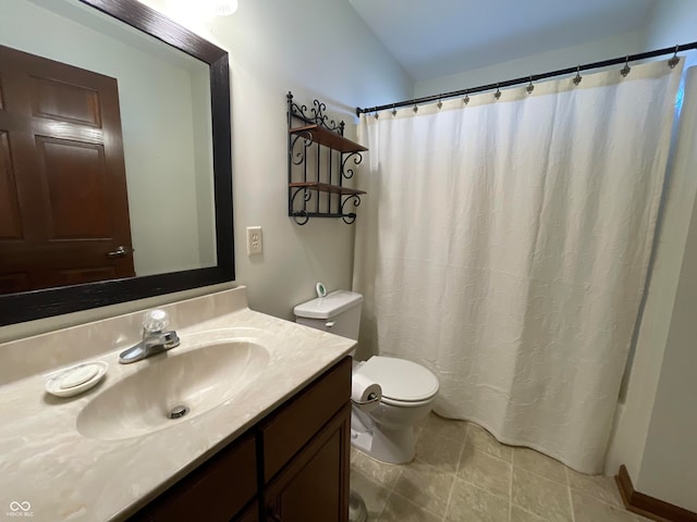 bathroom featuring vanity, toilet, and tile patterned flooring