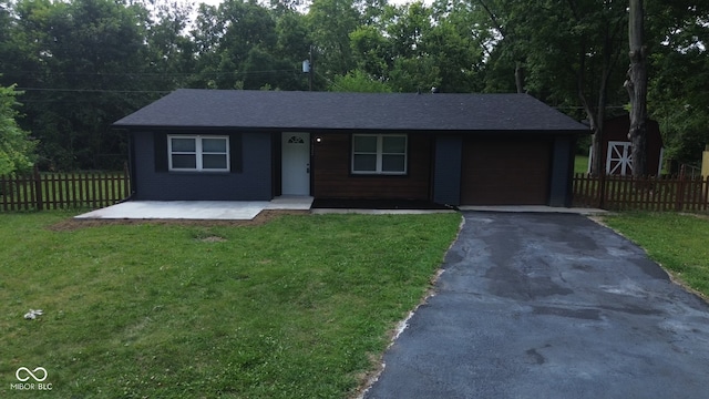 ranch-style house with a garage, a front lawn, and covered porch