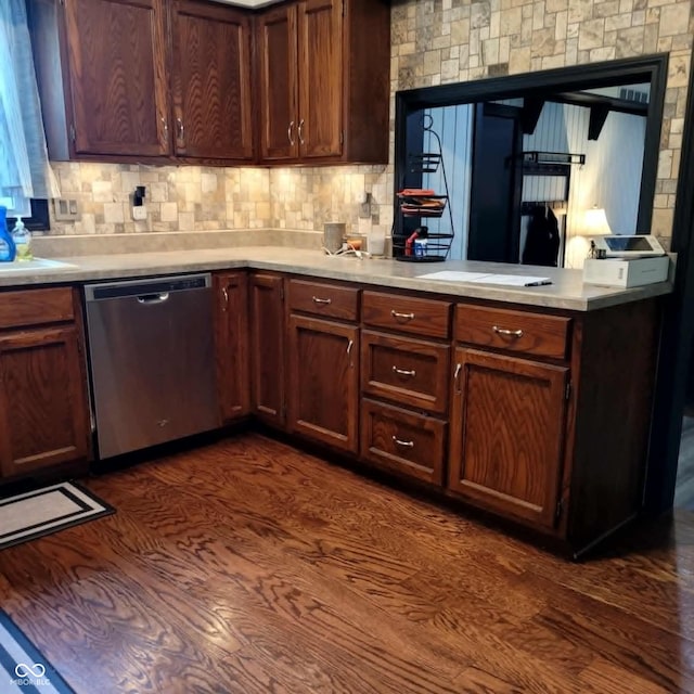 kitchen featuring dishwasher, dark hardwood / wood-style flooring, and tasteful backsplash