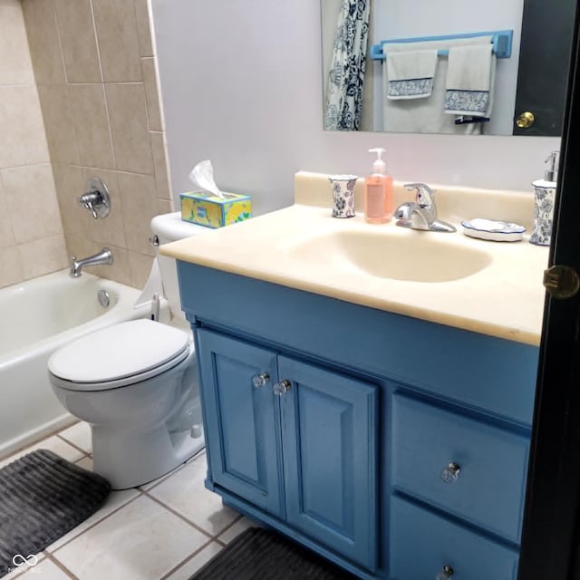 full bathroom featuring vanity, tiled shower / bath combo, toilet, and tile patterned floors