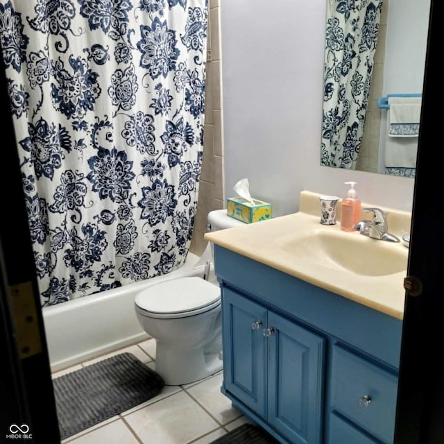 full bathroom featuring shower / bathtub combination with curtain, vanity, tile patterned floors, and toilet