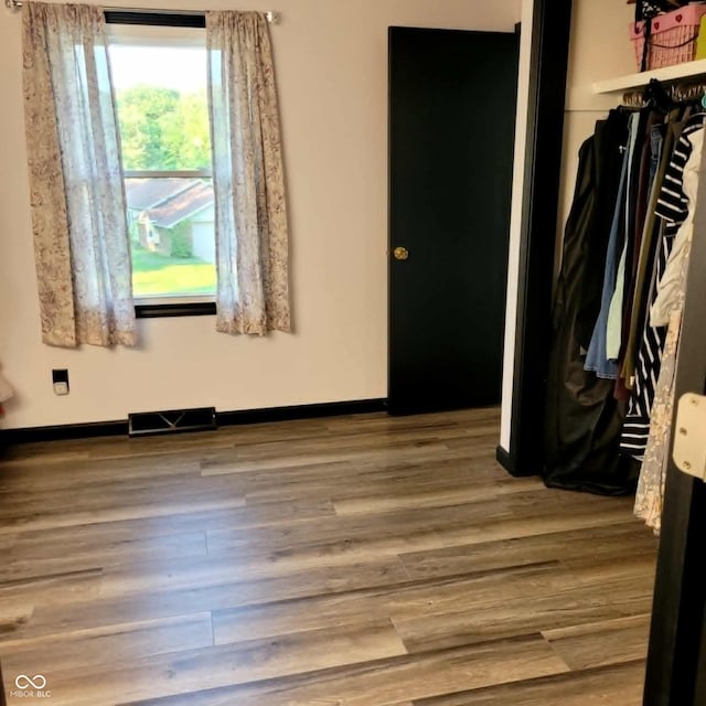 unfurnished bedroom with a closet and wood-type flooring