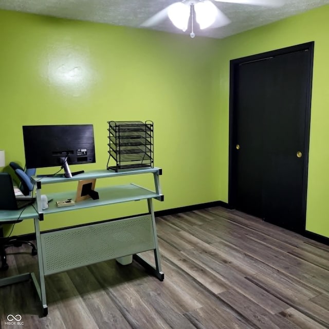 office area with a textured ceiling, ceiling fan, and hardwood / wood-style floors