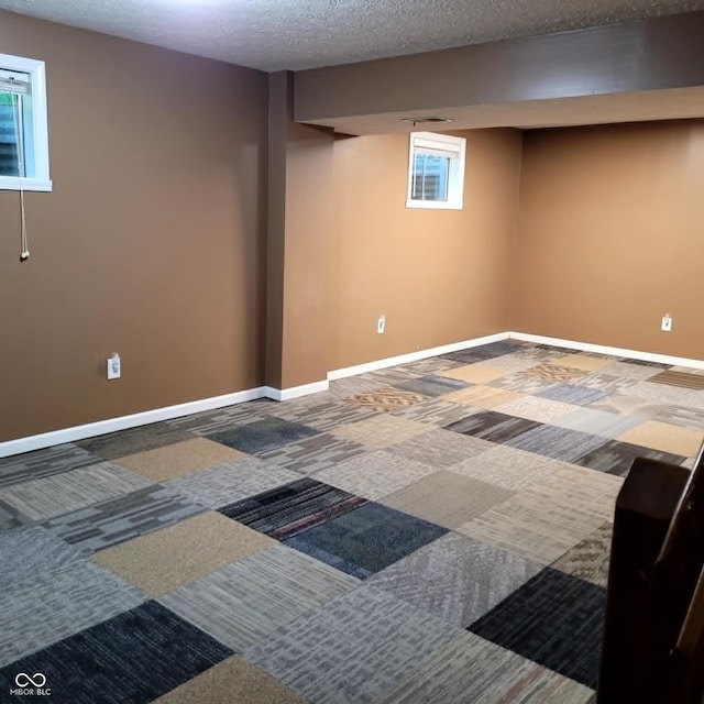 basement with carpet floors and a textured ceiling