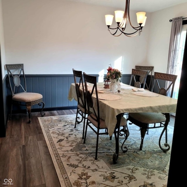 dining room featuring a notable chandelier and dark hardwood / wood-style flooring