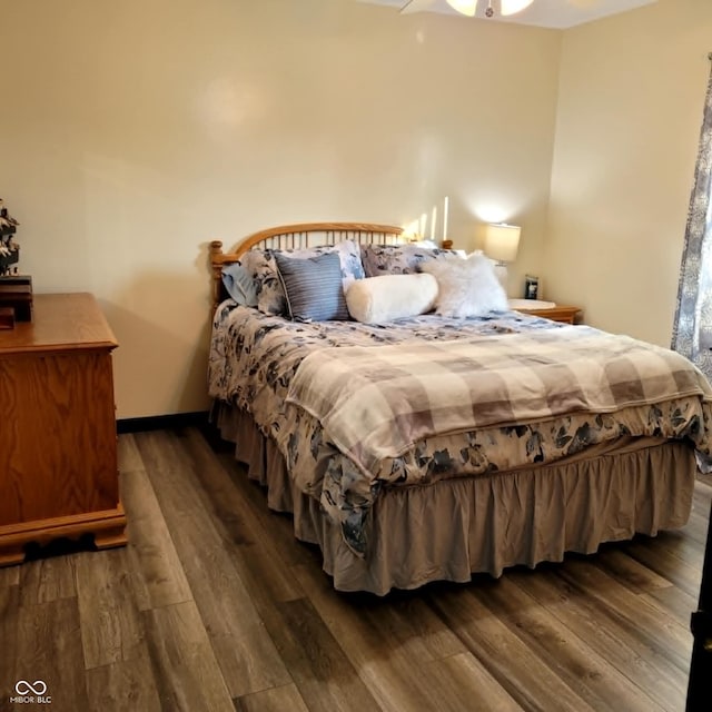 bedroom with dark wood-type flooring and ceiling fan