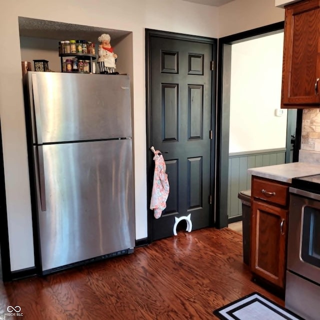 kitchen featuring appliances with stainless steel finishes and dark hardwood / wood-style flooring