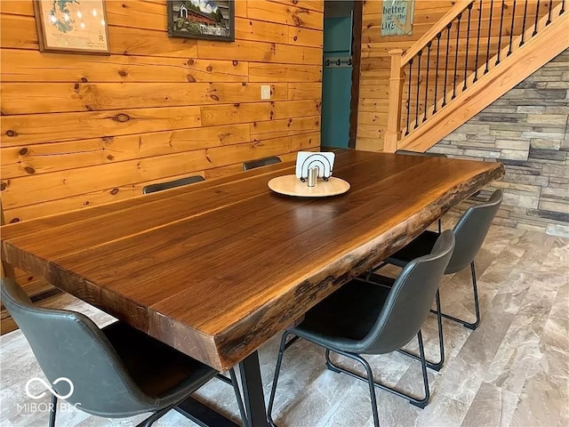 dining room with wooden walls