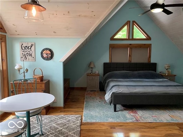 bedroom with lofted ceiling, ceiling fan, hardwood / wood-style floors, and wood ceiling