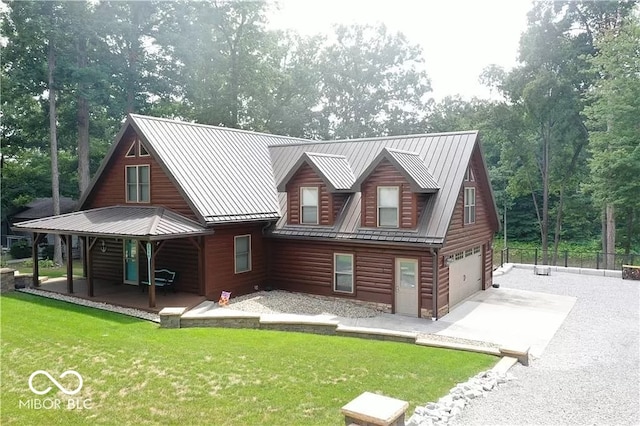 rear view of house with a garage and a lawn