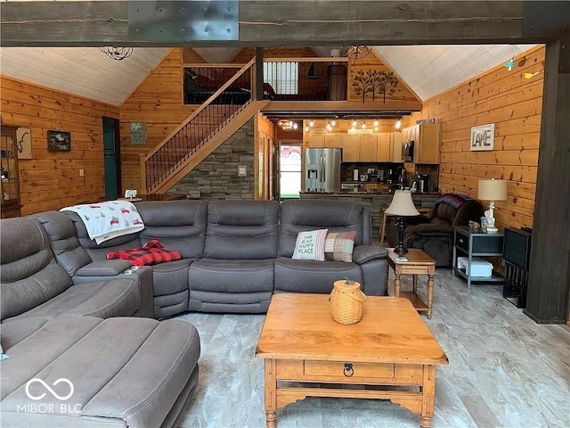 living room with wooden walls and high vaulted ceiling