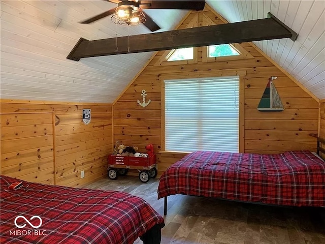 bedroom featuring wooden walls, vaulted ceiling with skylight, hardwood / wood-style floors, and ceiling fan