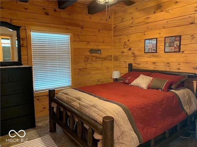 tiled bedroom featuring beamed ceiling, ceiling fan, and wood walls