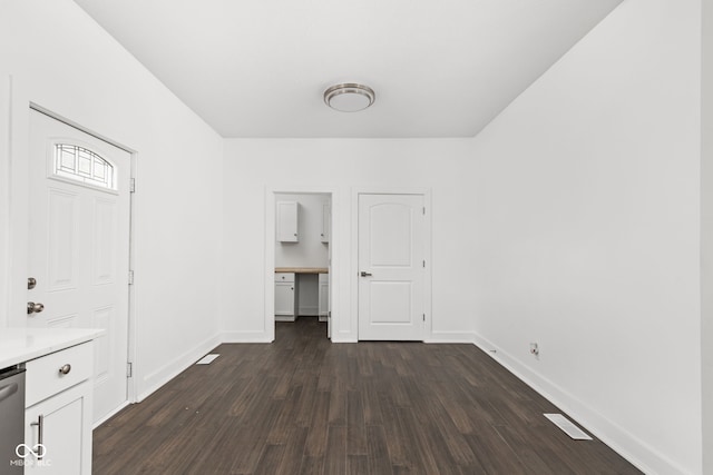 unfurnished bedroom with dark wood-type flooring