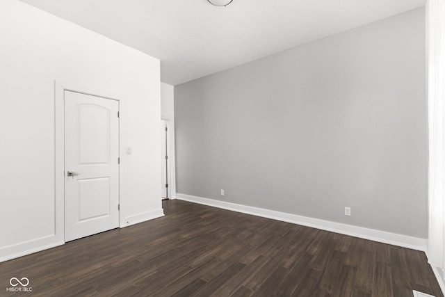 empty room featuring dark hardwood / wood-style flooring