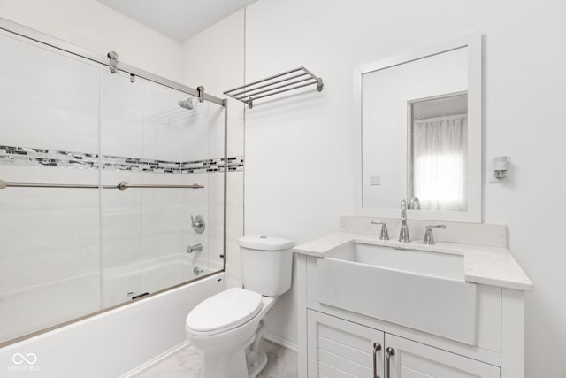 full bathroom with vanity, toilet, and bath / shower combo with glass door