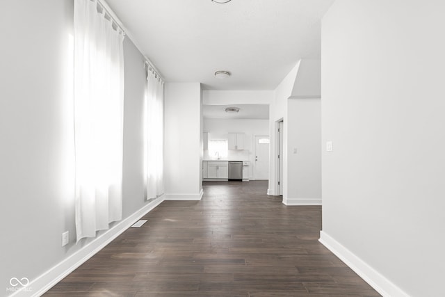 corridor featuring sink and dark hardwood / wood-style flooring