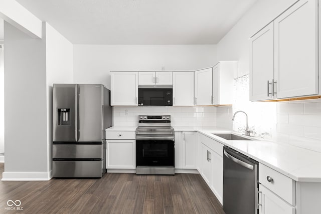 kitchen featuring appliances with stainless steel finishes, dark hardwood / wood-style floors, sink, and white cabinetry