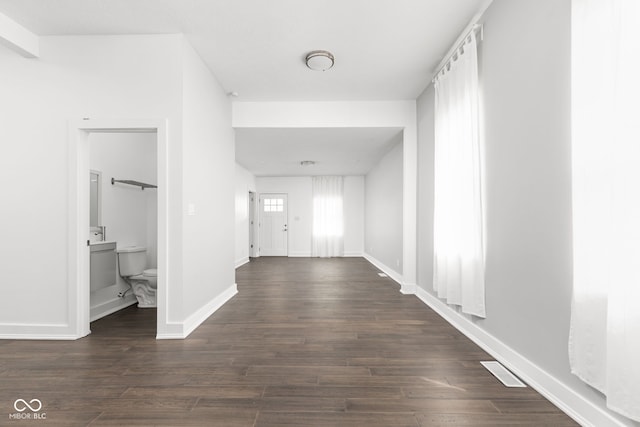 hallway with dark hardwood / wood-style floors