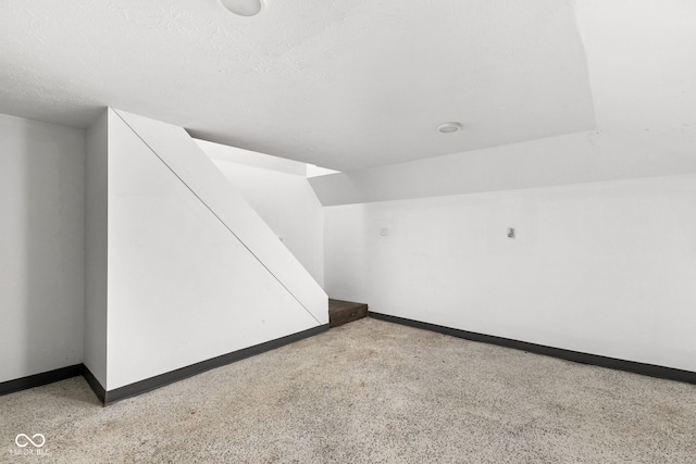 additional living space with a textured ceiling