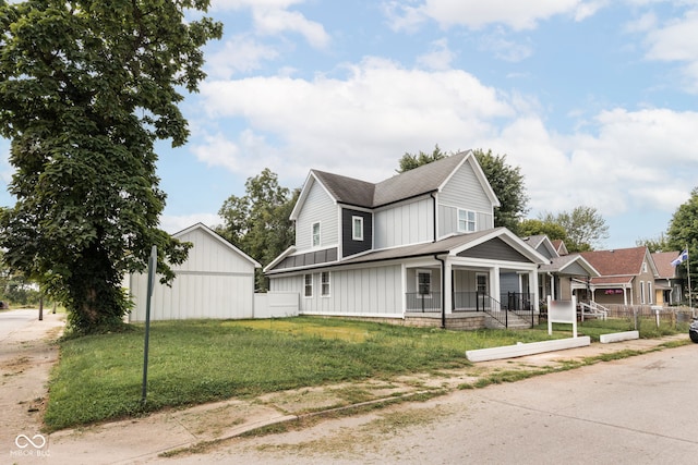 view of front facade with a front lawn and a porch