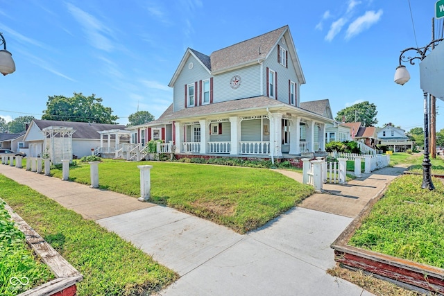 view of front of house featuring covered porch and a front lawn