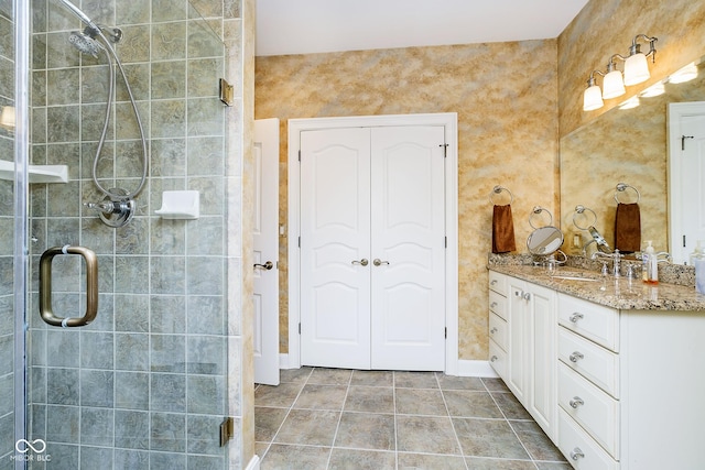 bathroom with vanity, tile patterned floors, and walk in shower