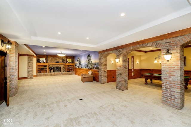8358 Hidden Point Dr, Indianapolis, IN 46256 - living room with decorative columns, billiards table, arched walkways, wainscoting, and carpet