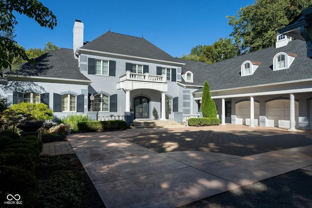 view of front of home with a balcony and a garage