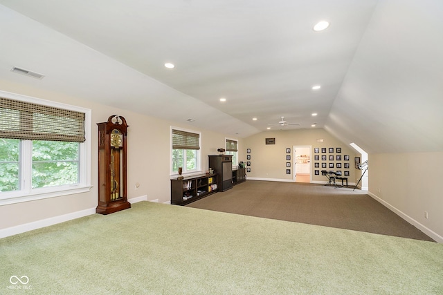 interior space with carpet flooring, ceiling fan, and lofted ceiling