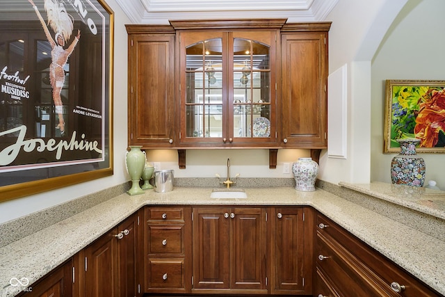 8358 Hidden Point Dr, Indianapolis, IN 46256 - kitchen featuring glass insert cabinets, light stone counters, and crown molding