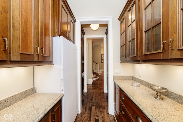 kitchen featuring light stone countertops and dark hardwood / wood-style flooring