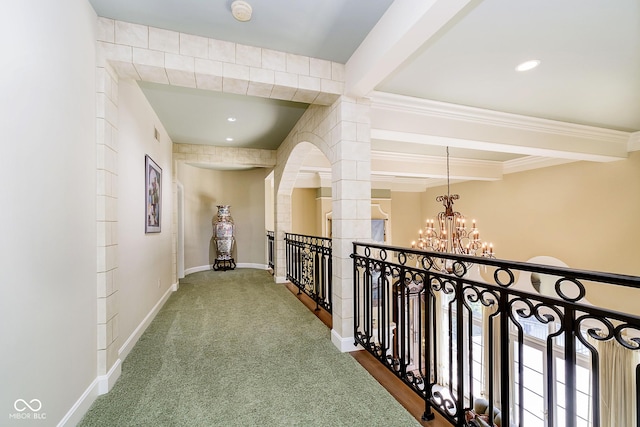 8358 Hidden Point Dr, Indianapolis, IN 46256 - hall featuring a chandelier, beam ceiling, an upstairs landing, carpet floors, and ornate columns