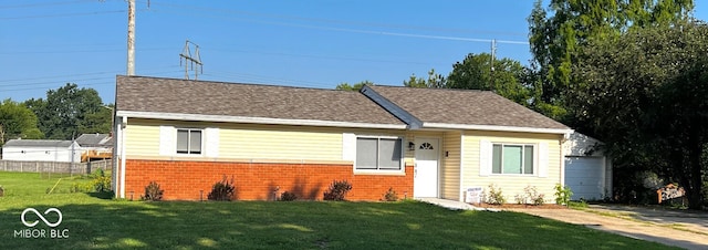 view of front of property with a garage and a front yard