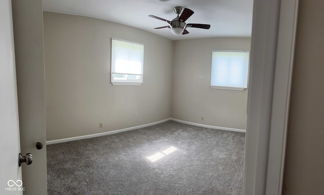 carpeted spare room featuring ceiling fan