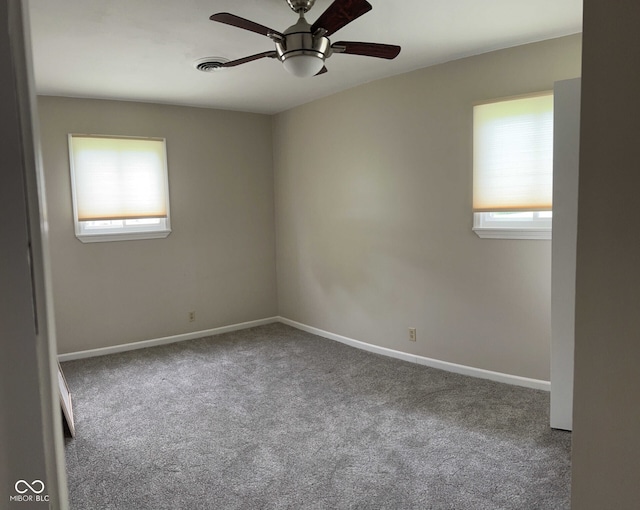 carpeted empty room featuring ceiling fan and a healthy amount of sunlight