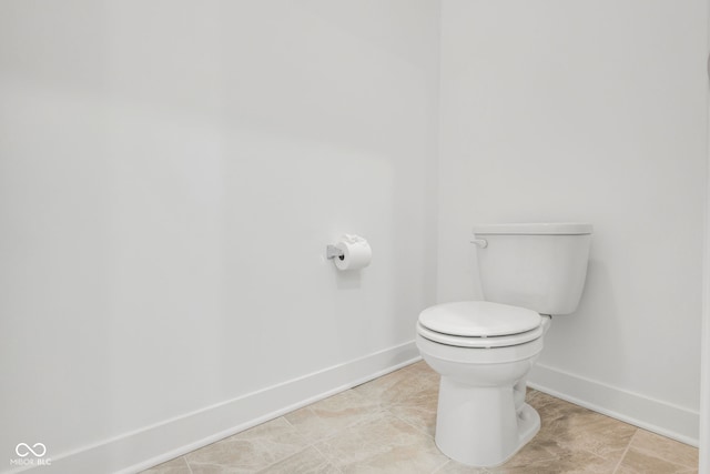 bathroom featuring tile patterned flooring and toilet