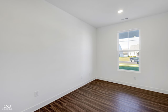 spare room with dark hardwood / wood-style flooring