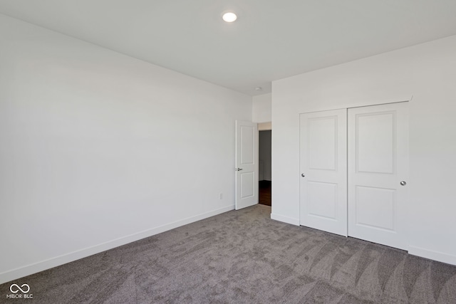 unfurnished bedroom with a closet and carpet