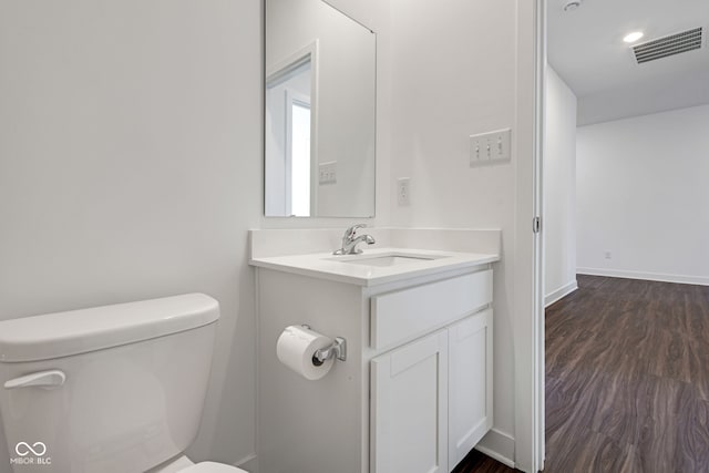 bathroom featuring vanity, toilet, and wood-type flooring