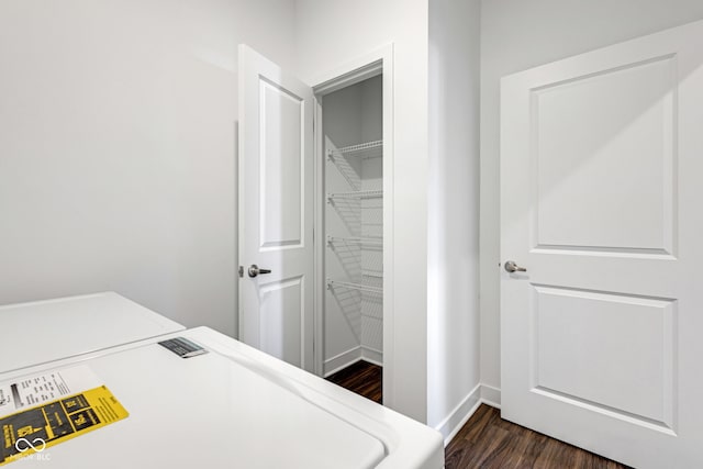 laundry area with dark wood-type flooring